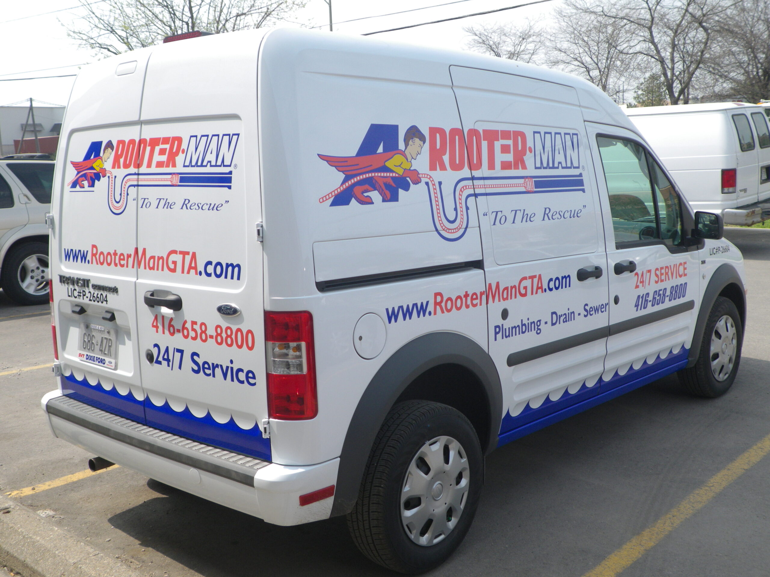 A White Van Wrapped with Rooter Man's Branded Graphics